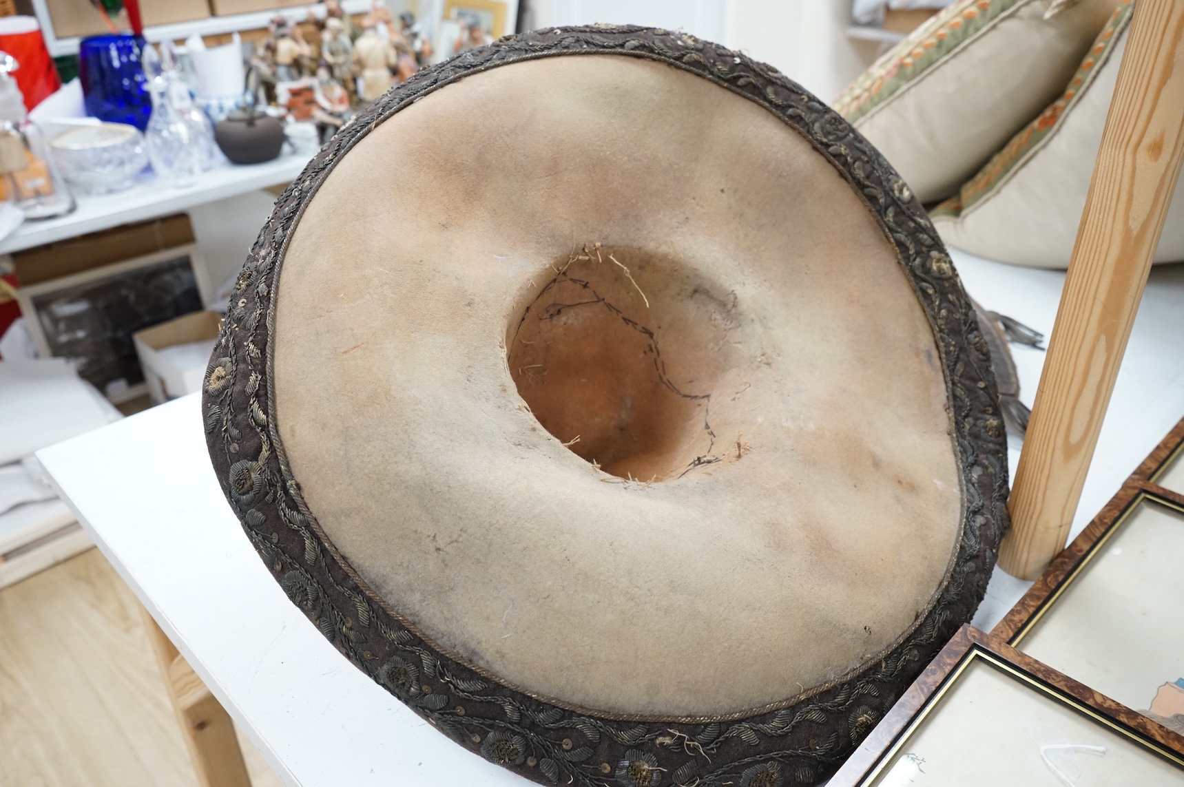 A Spanish Colonial leather saddle and a Spanish Colonial bullion work sombrero, saddle 59cm long